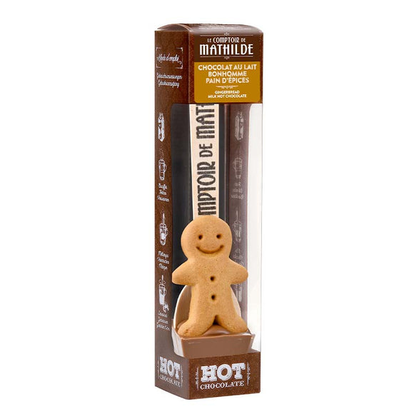 Cuchara con chocolate para hacer chocolate caliente. Chocolate con leche y galleta de jengibre